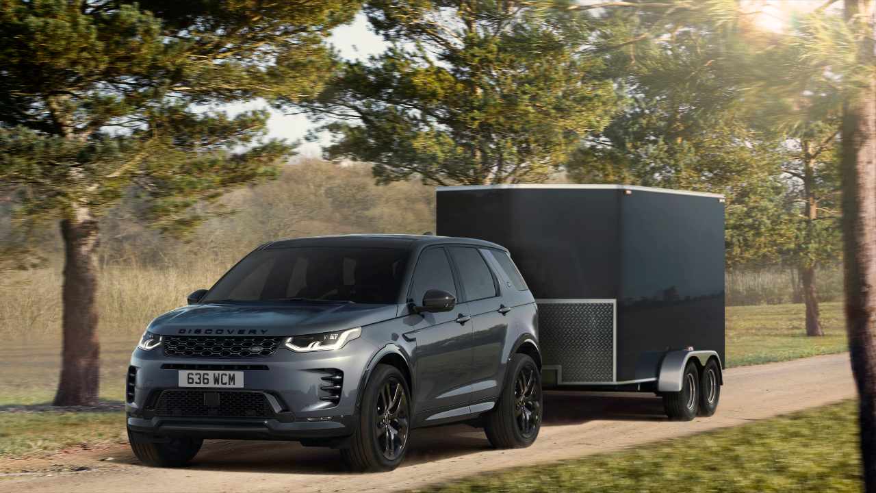 Dark grey Land Rover discovery sport towing black trailer