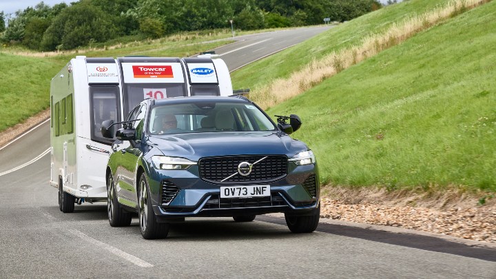 Blue Volvo XC60 towing a white caravan