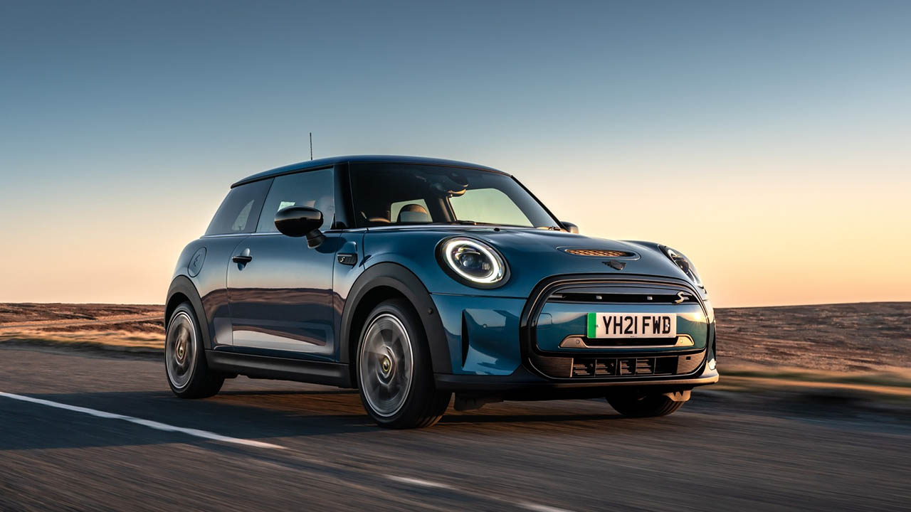 mini electric, driving in sunset