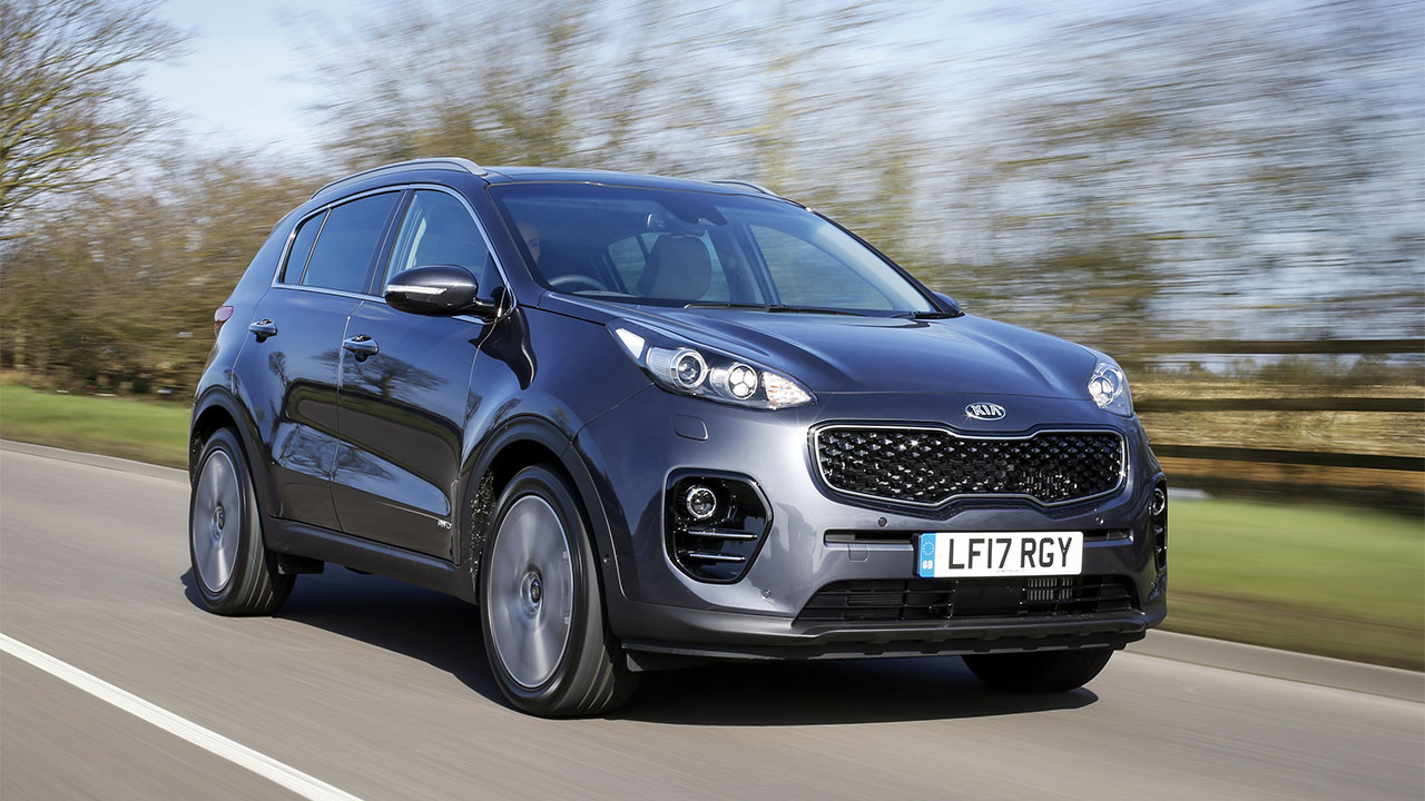 Grey Kia Sportage, driving