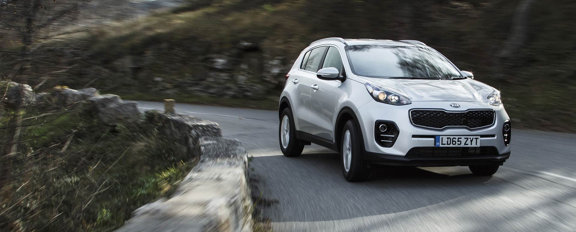 Silver Kia Sportage, cornering