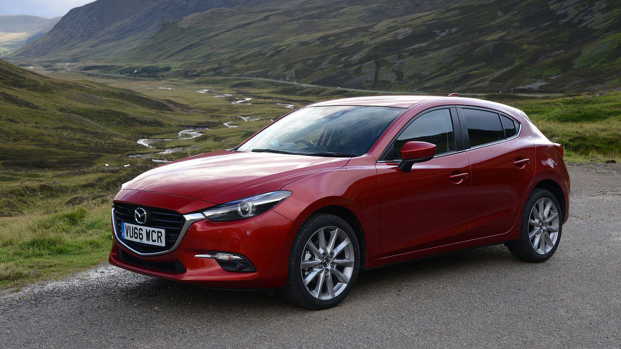 Red Mazda3, parked