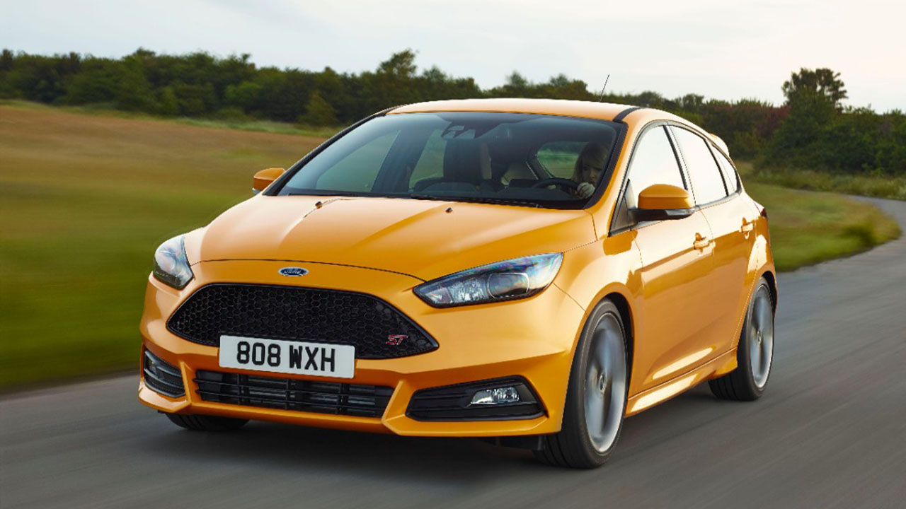 orange ford focus st driving
