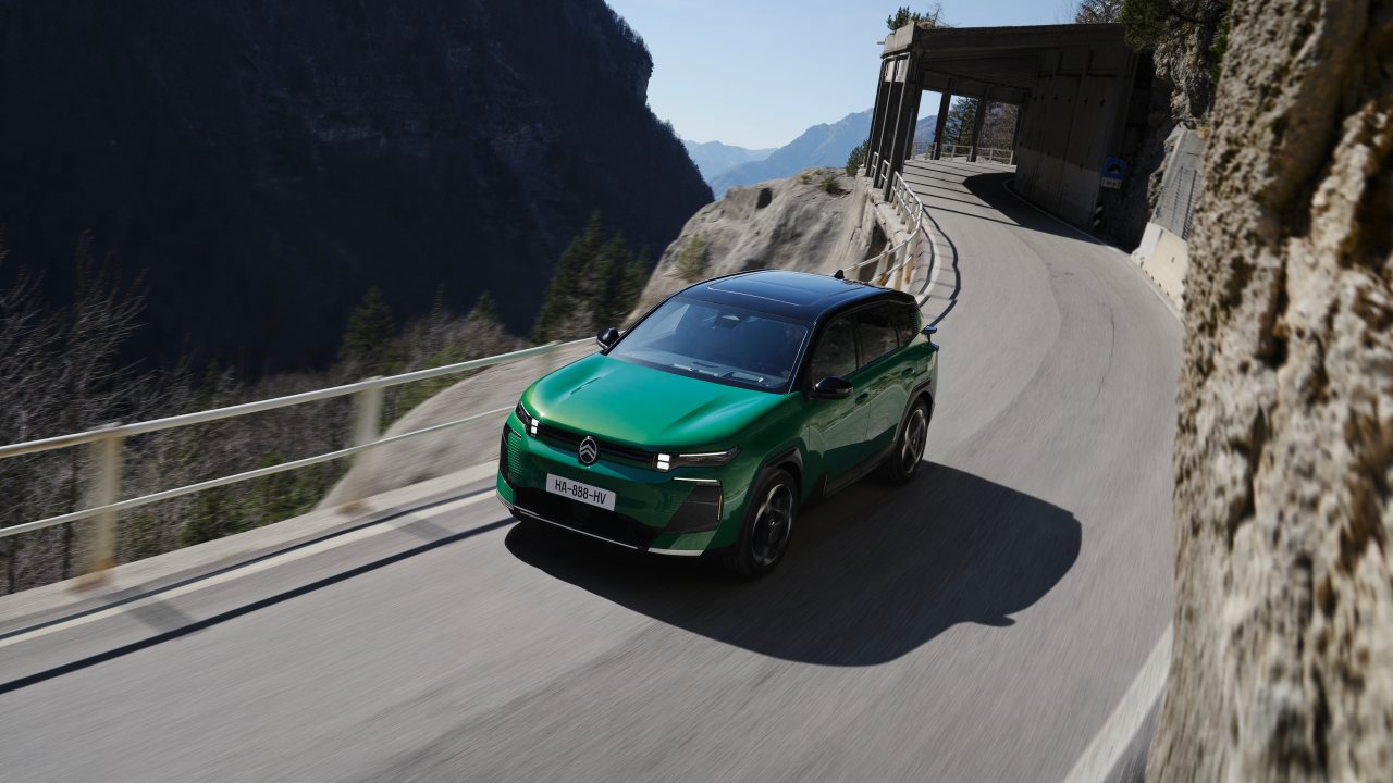 Green Citroen C5 Aircross driving down mountain road