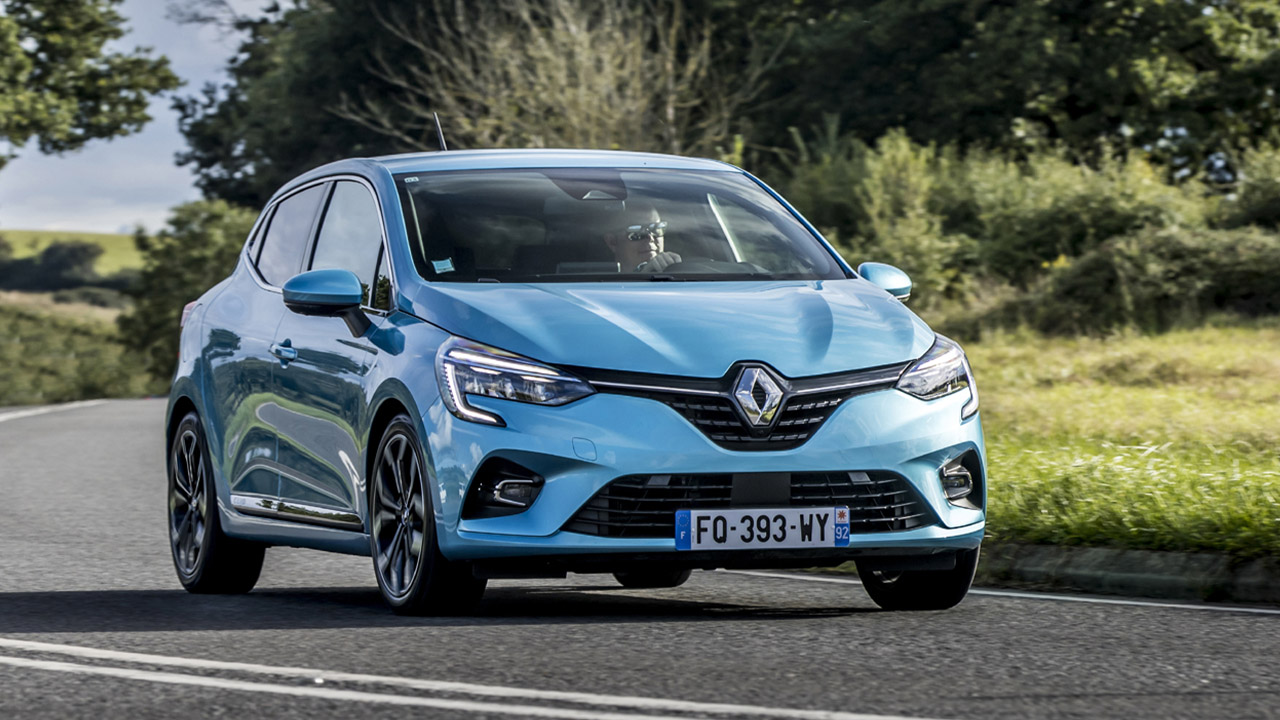 Blue Renault Clio driving in countryside