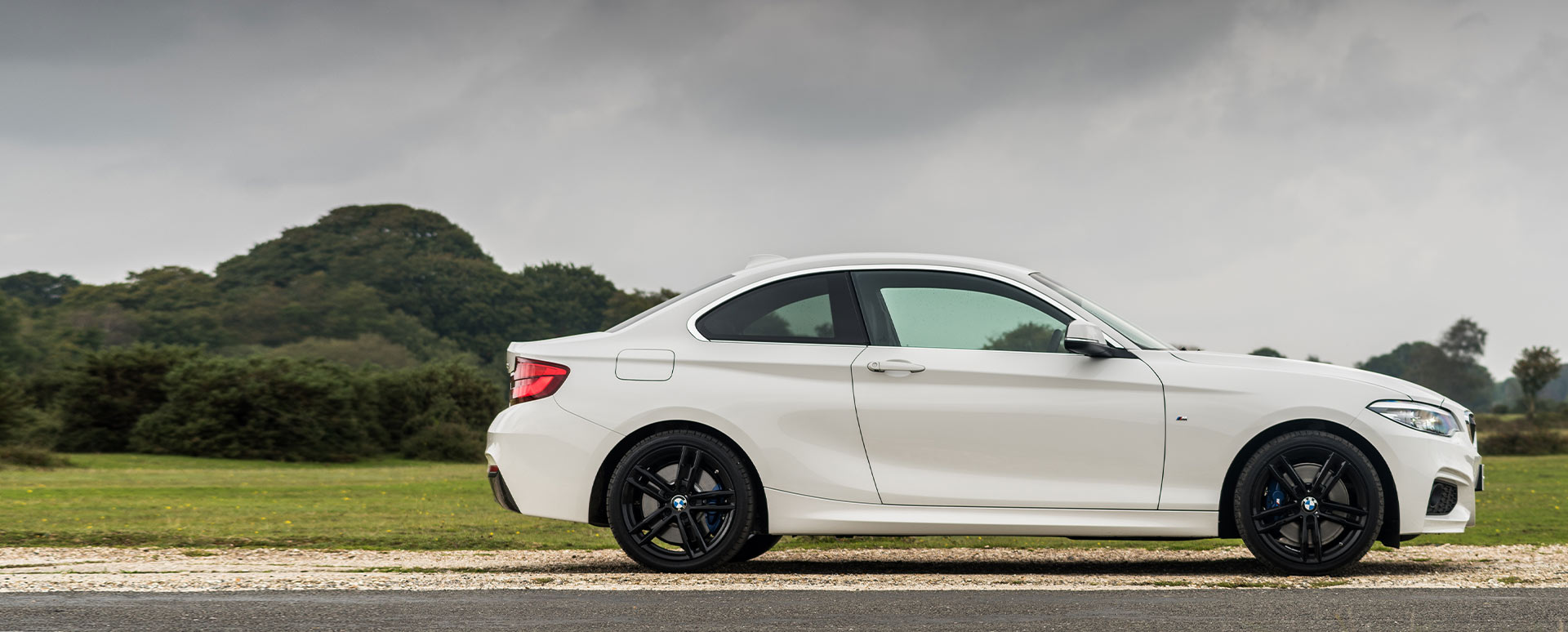 White BMW 2 Series, side profile