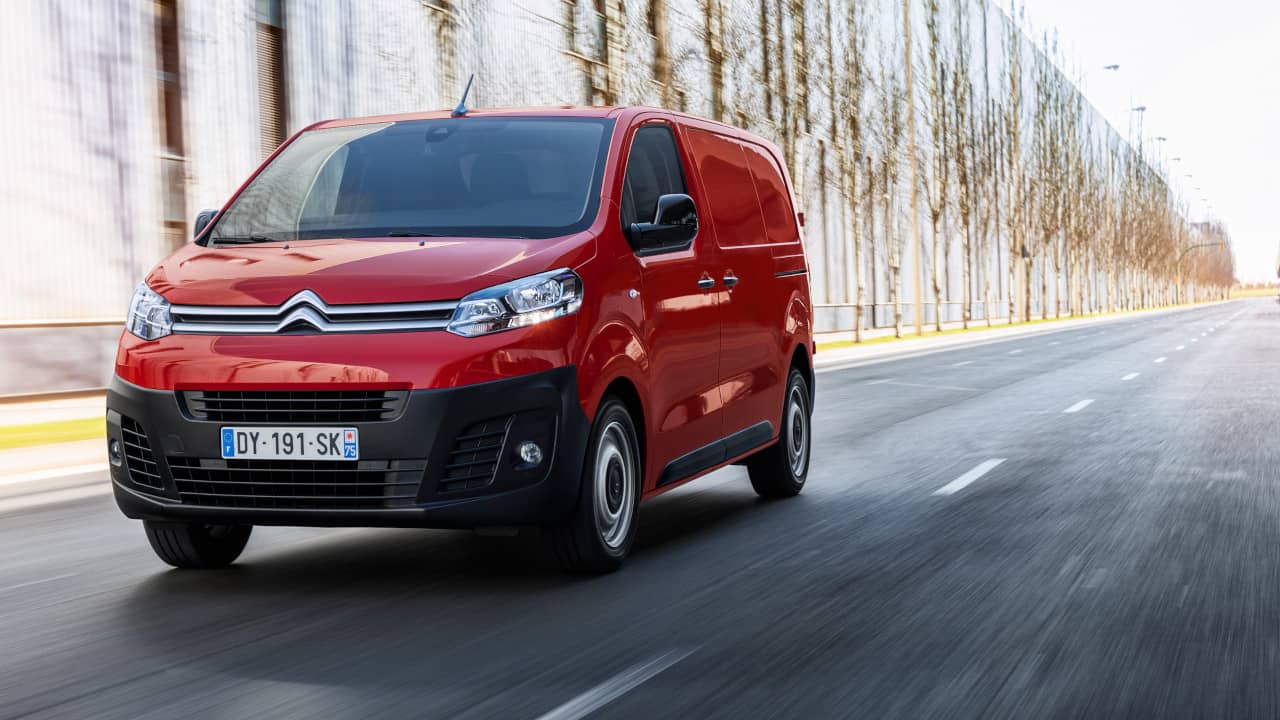 Red Citroen Dispatch Exterior Front Driving Along Road With Trees