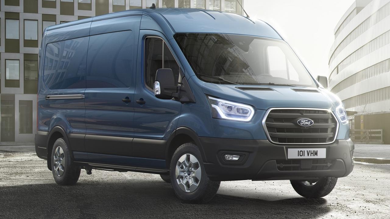 Blue Ford Transit parked in front of a couple of buildings