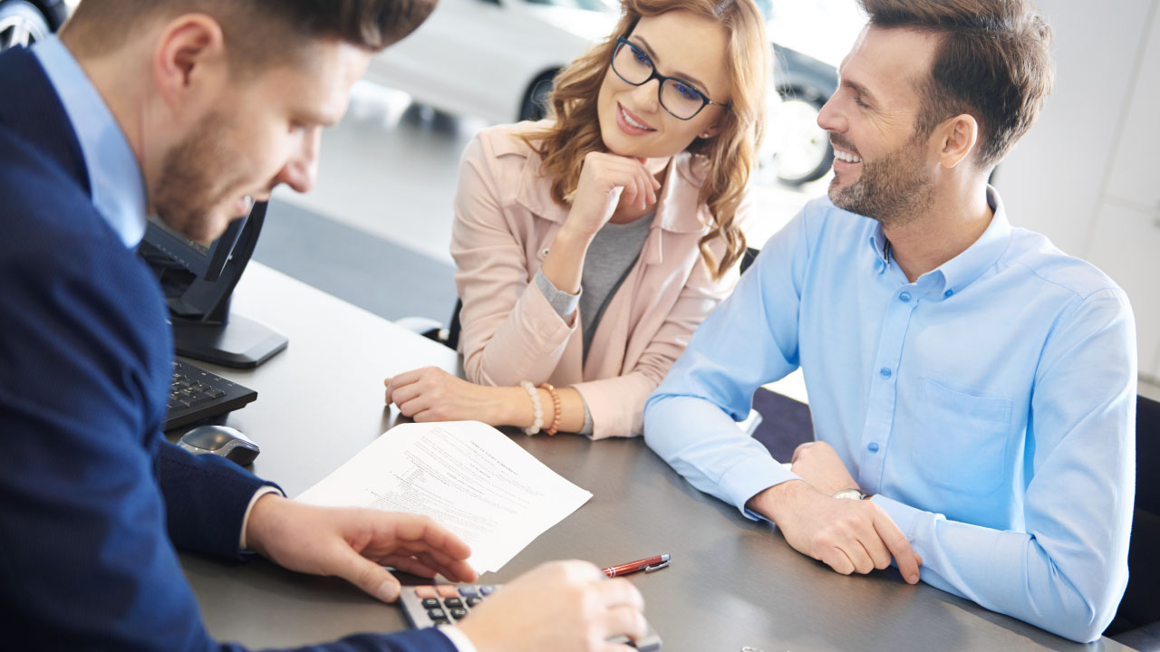 Three people negotiating a contract