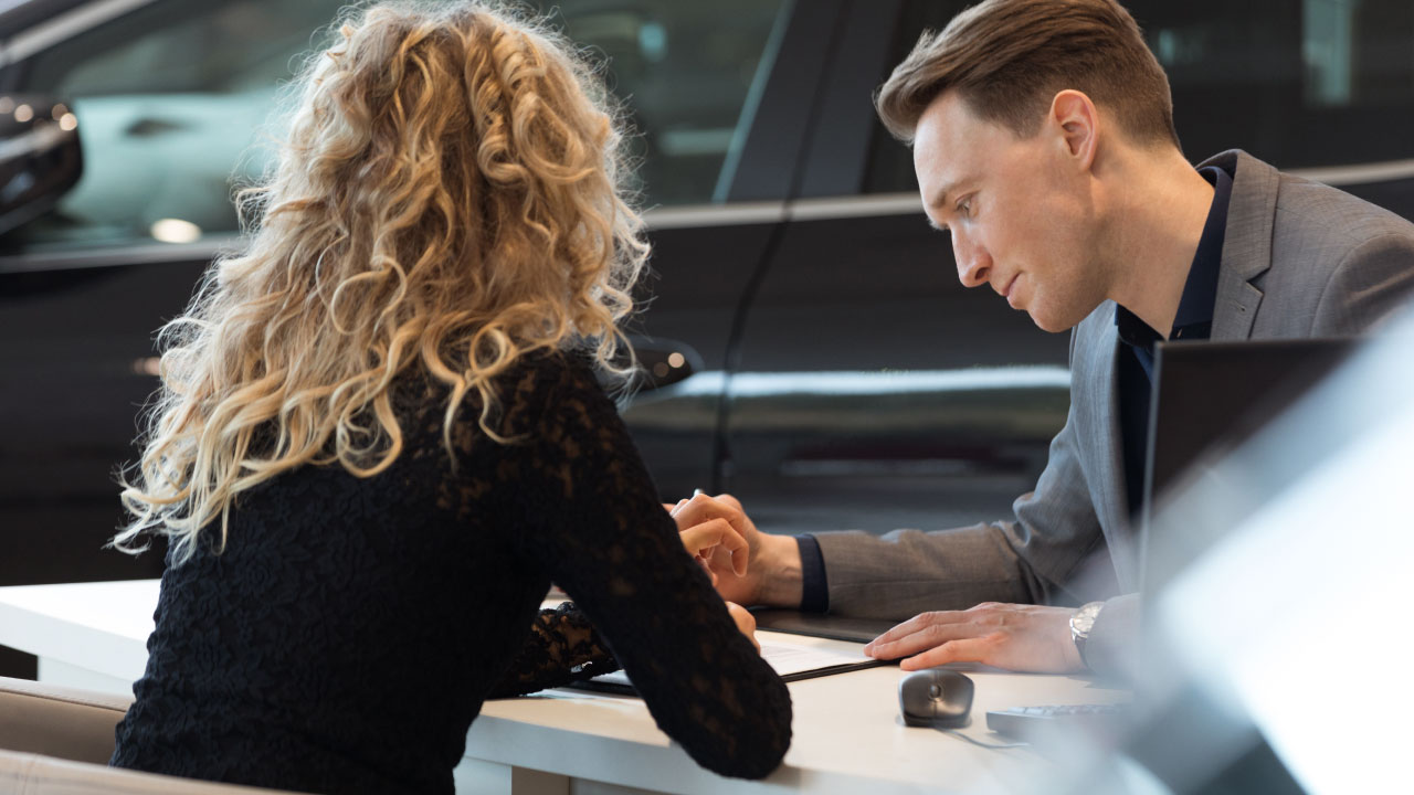 A man and a woman reading through a contract