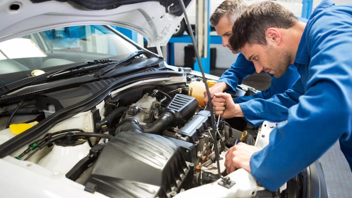 Technicians inspecting air conditioning system