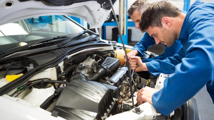 Technicians inspecting air conditioning system