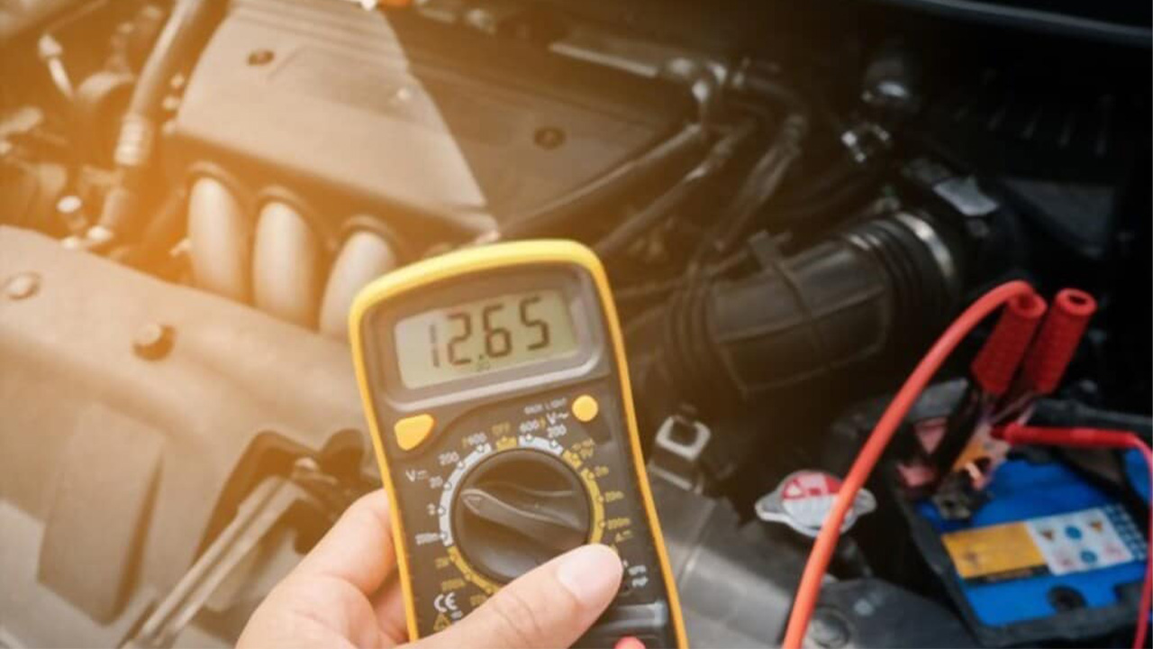 Technician checking health of a car battery
