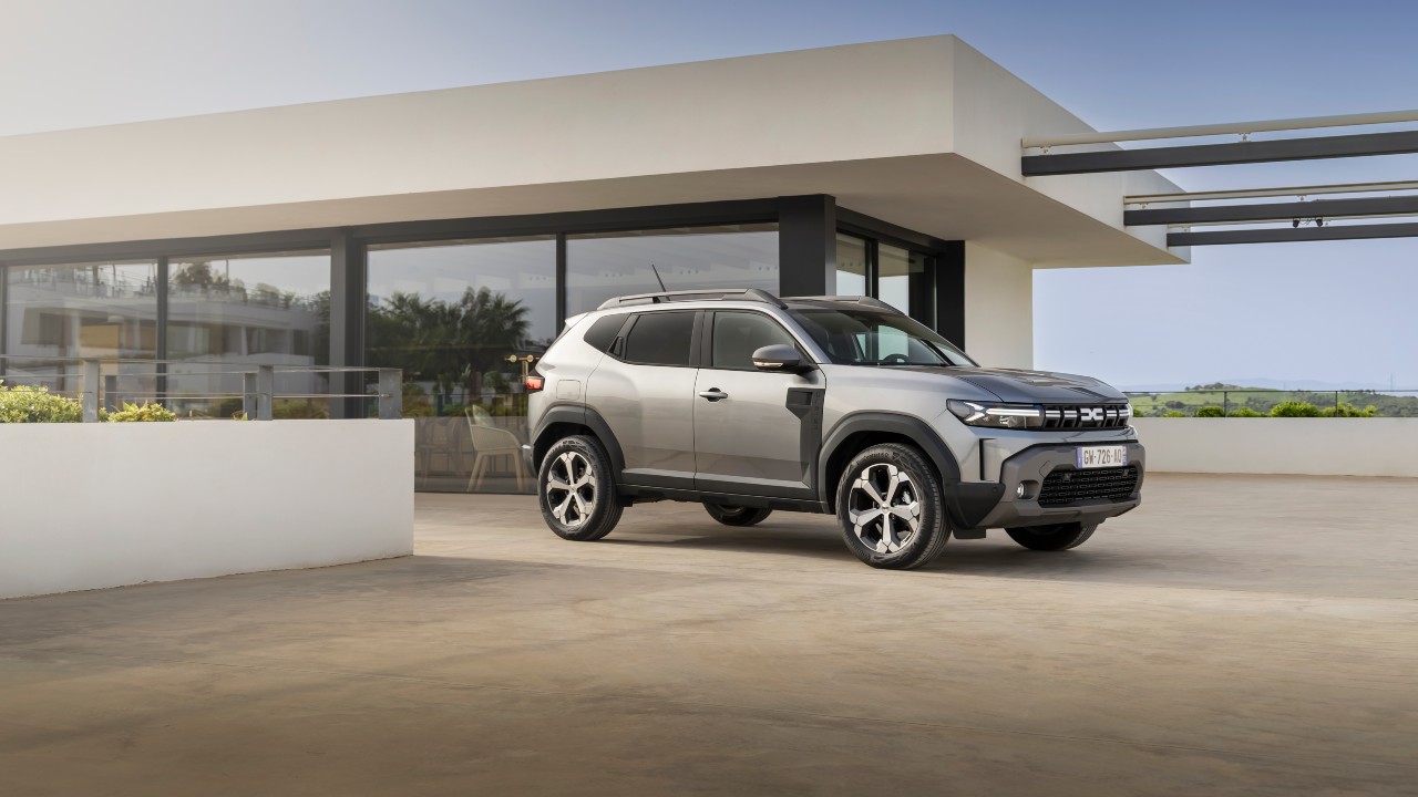 Grey Dacia Duster static outside modern house