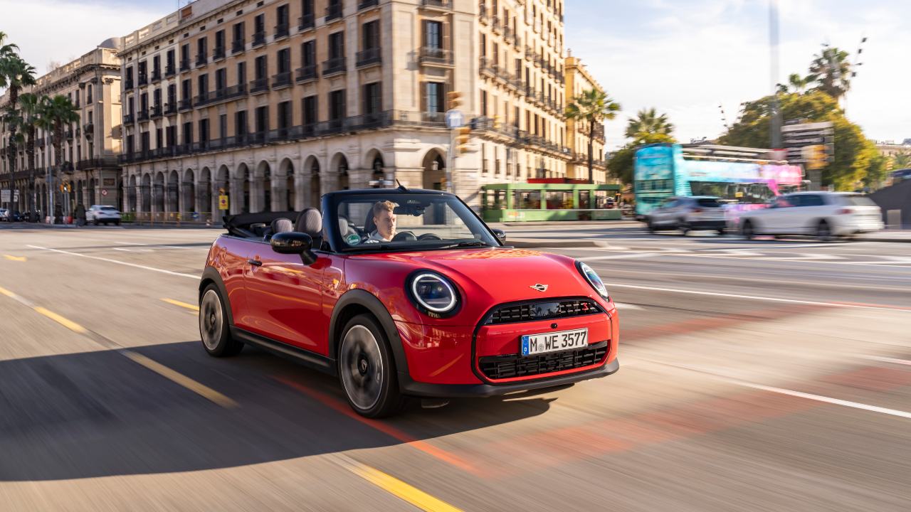 Orange Mini cooper convertible driving