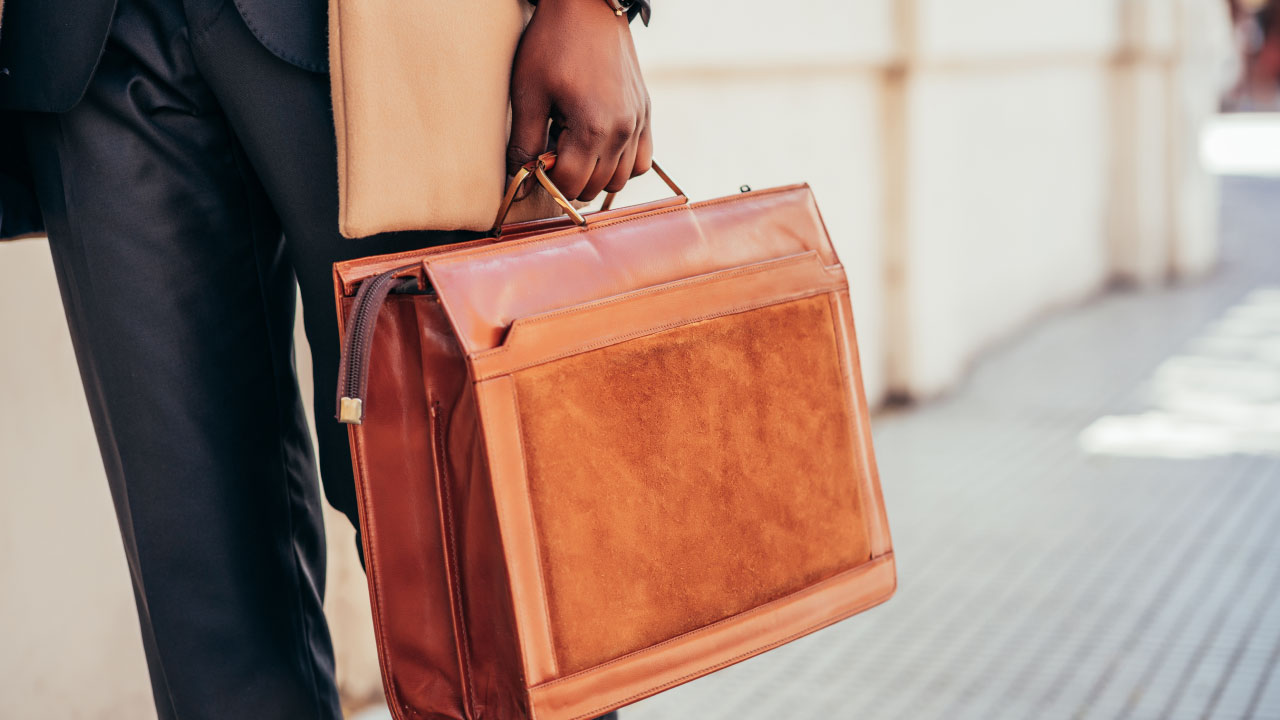 Man holding a brown brief case