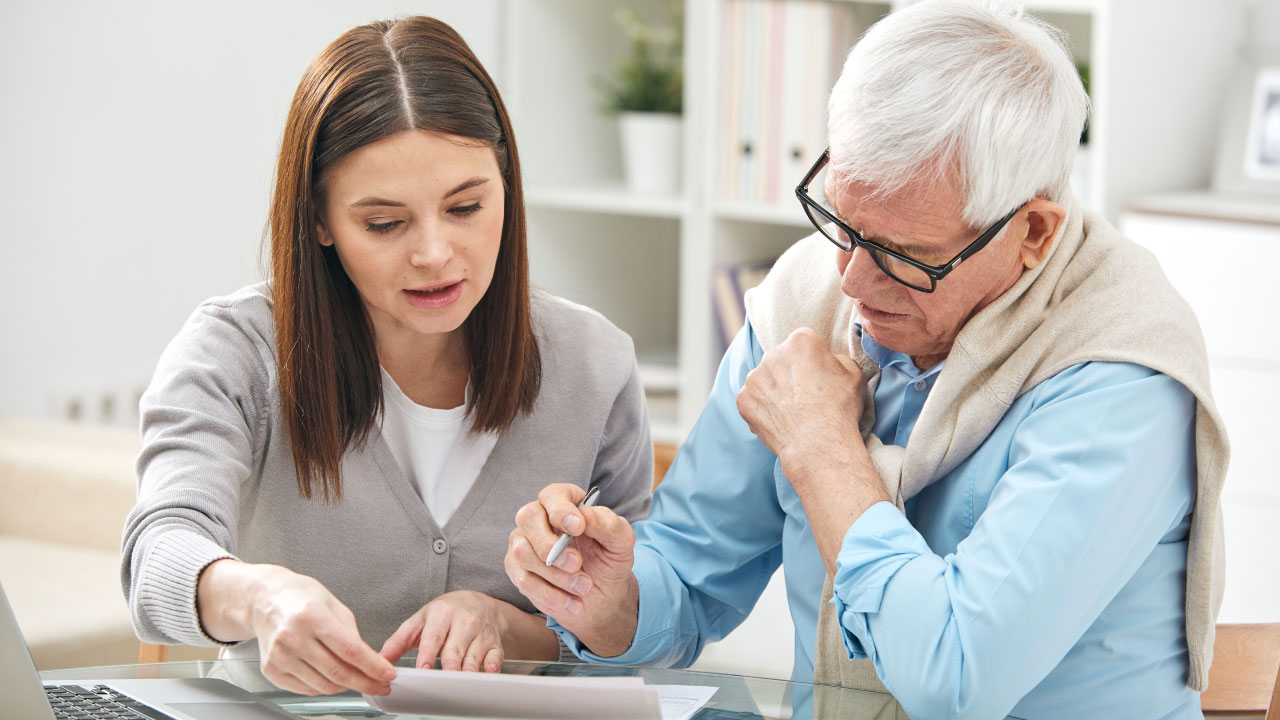 Two people checking contracts