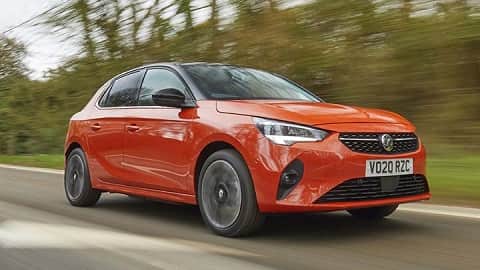 Orange Vauxhall Corsa, driving in the countryside