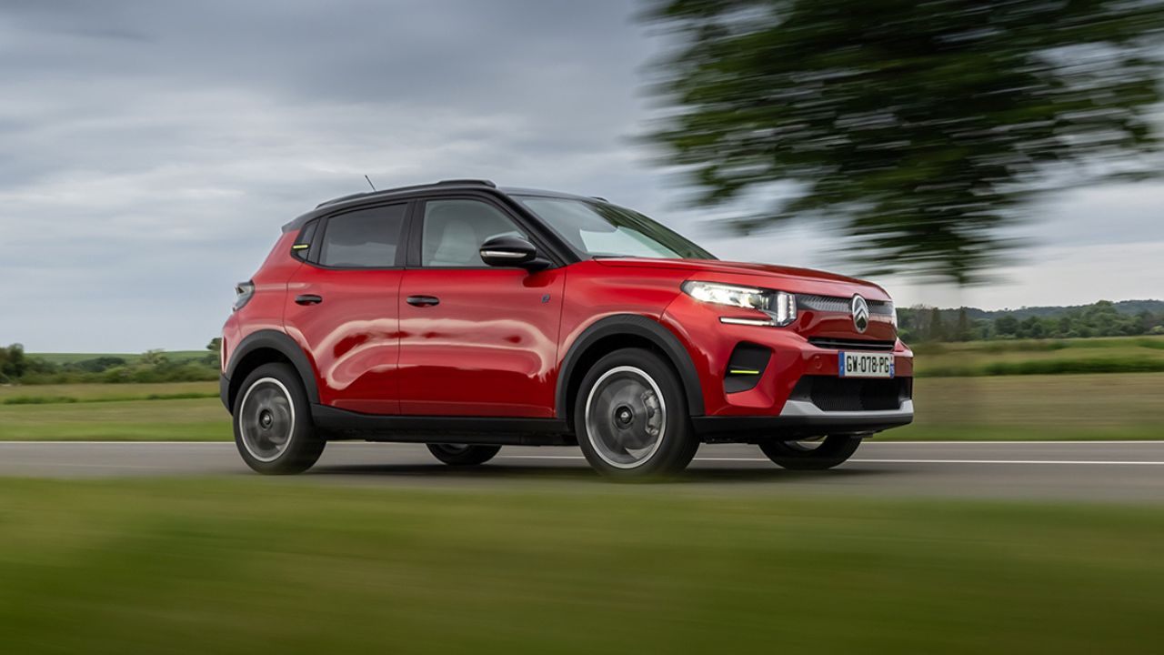 Red Citroen e-C3 driving in the countryside