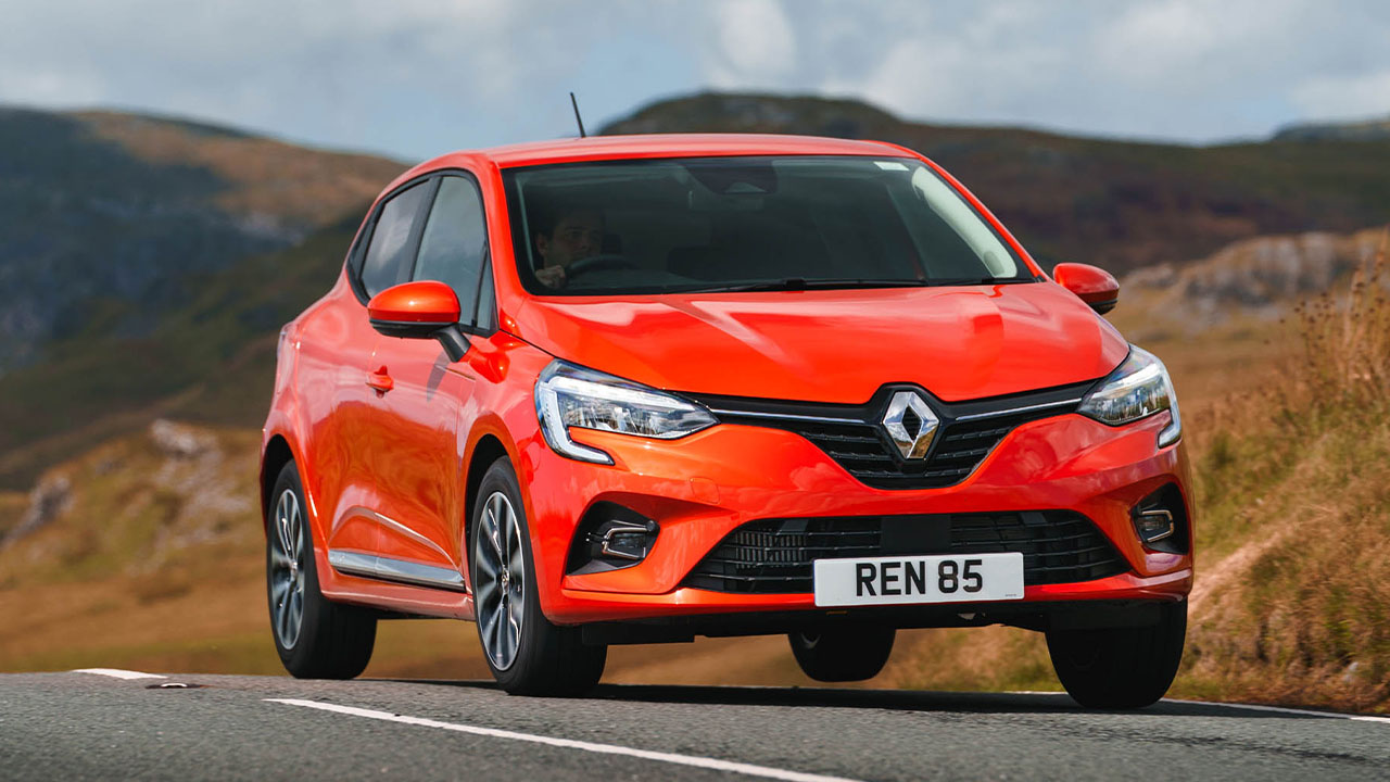 Orange Renault Clio, driving down country road