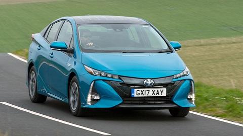 Blue Toyota Prius, driving down country road