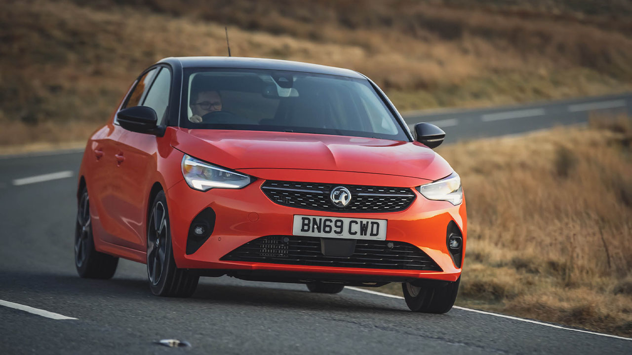 Orange Vauxhall Corsa, driving in countryside