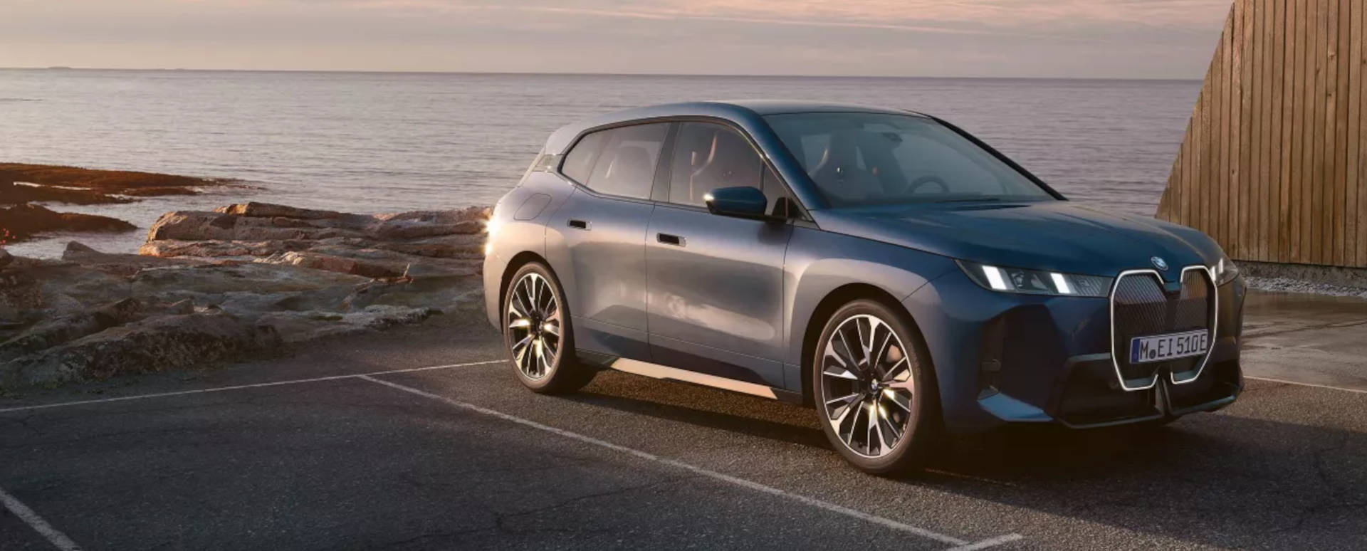 BMW iX Parked in Bay in Front Of Sea