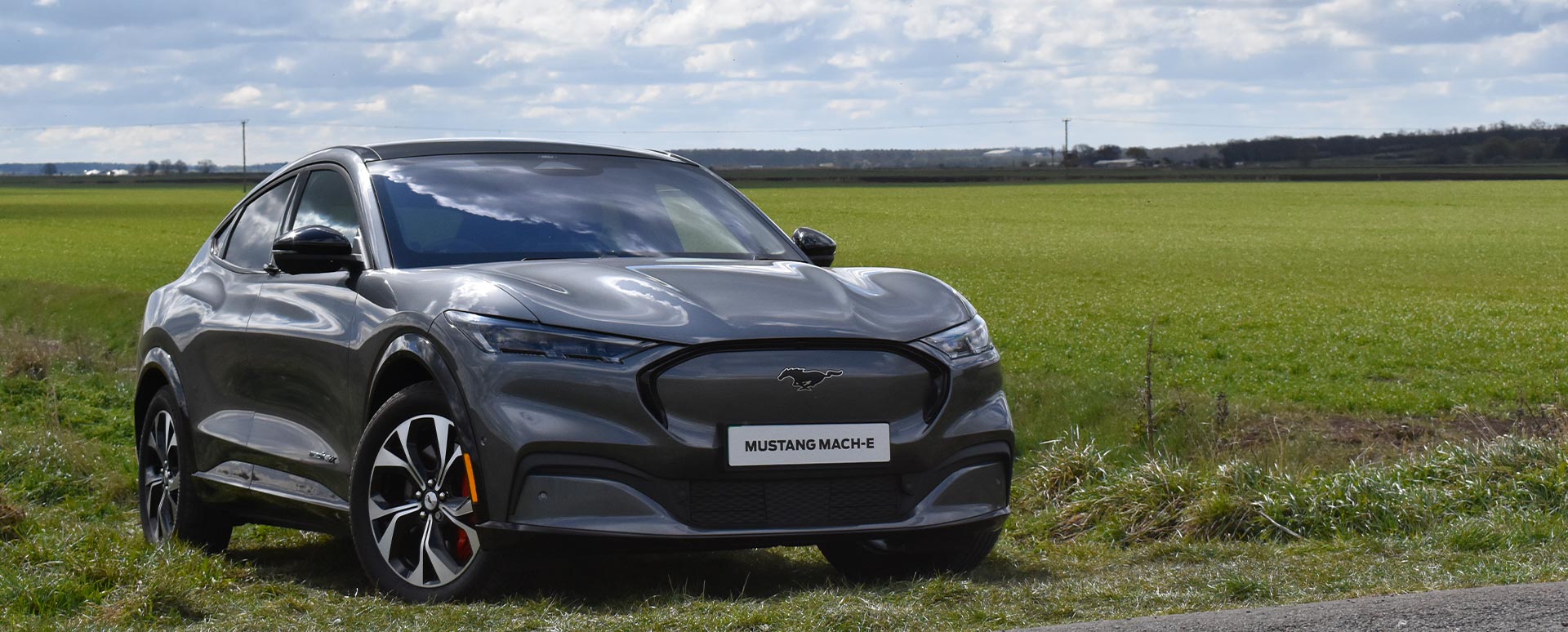 carbonised grey ford mustang mach-e, parked in countryside, front quarter