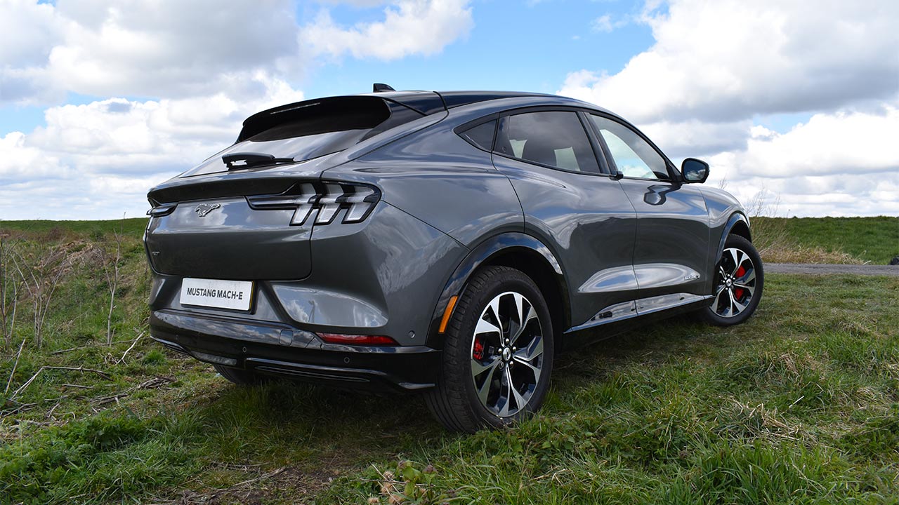 carbonised grey ford mustang mach-e, parked in countryside, rear quarter