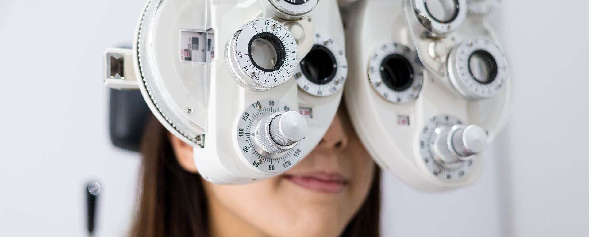 Woman with an eye test machine placed on her eyes