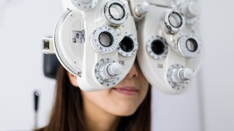 Woman with an eye test machine placed on her eyes