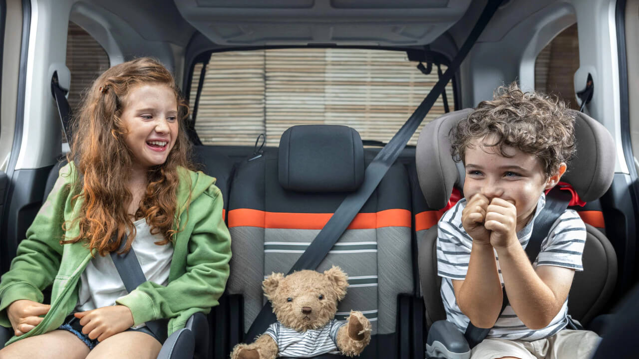 Children sat in Citroen Berlingo with a teddy bear