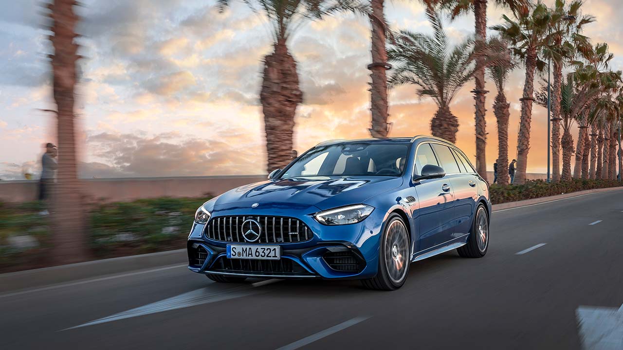 Blue Mercedes-AMG C63 Estate Exterior Front Driving on Coastal Road