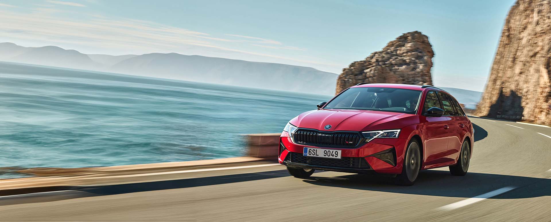 Red Skoda Octavia vRS Estate Exterior Front Driving on Coastal Road