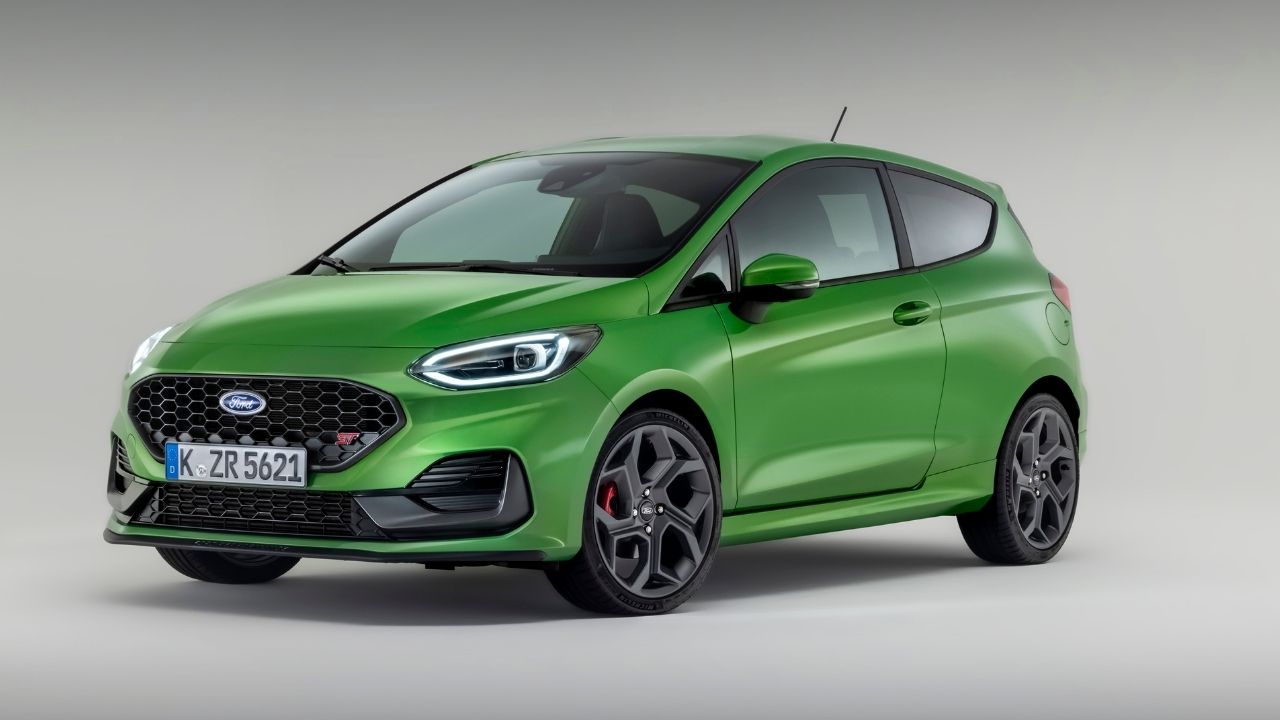 Green Ford Fiesta parked on a grey background