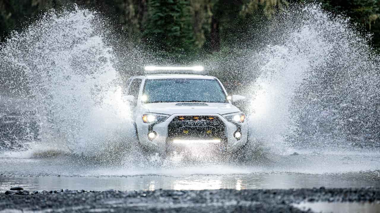Car Going Through Deep Puddle Of Water