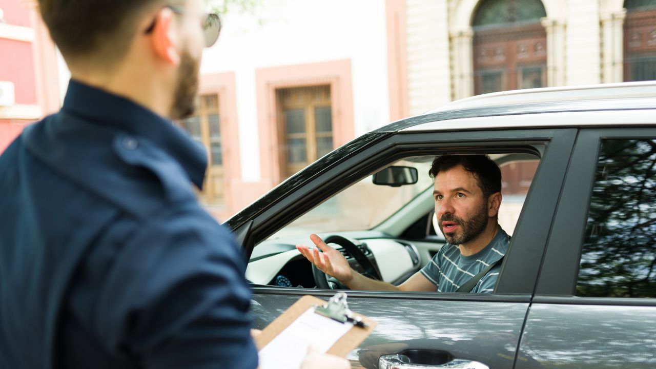 Police officer issuing a ticket to driver