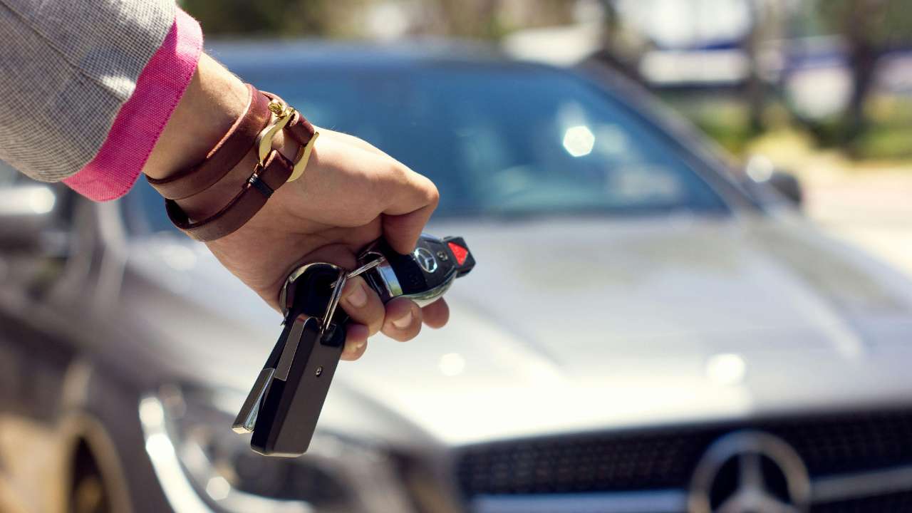 Woman holding a Mercedes-Benz key fob