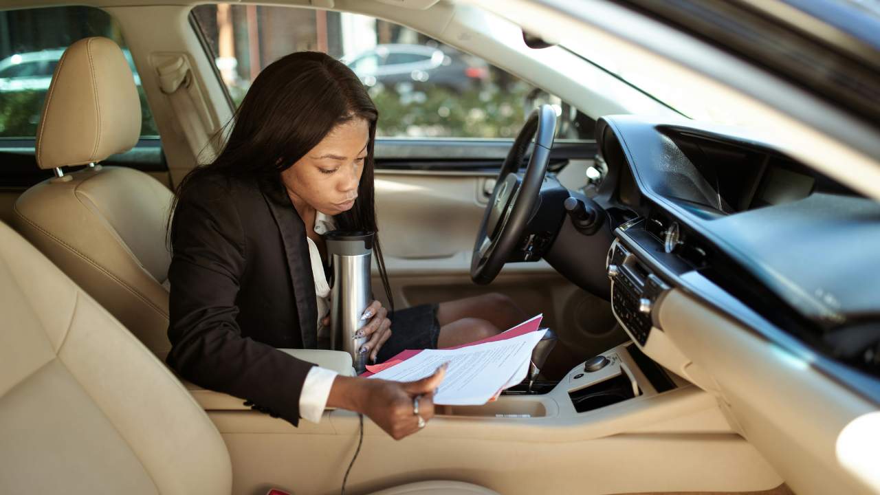 Woman revising documents in her car