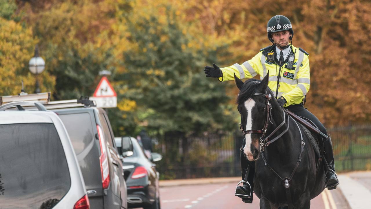 UK Police Officer Giving Hand Signals on Horse