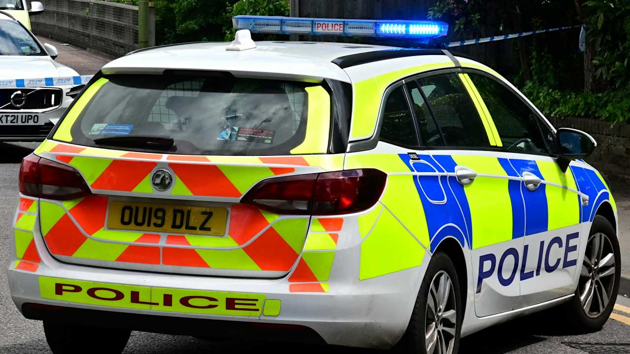 Rear of a Vauxhall Astra Police Car with Sirens On