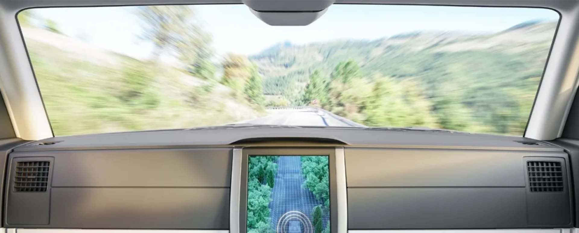 Render of a driverless car interior driving down a country road from the backseat perspective