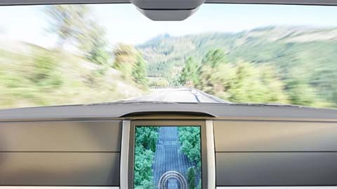 Render of a driverless car interior driving down a country road from the backseat perspective