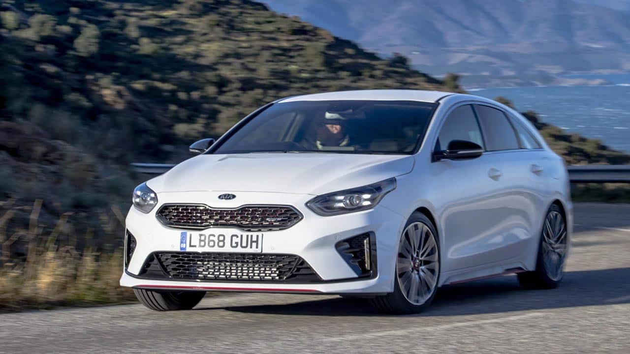 White Kia ProCeed, driving in the countryside