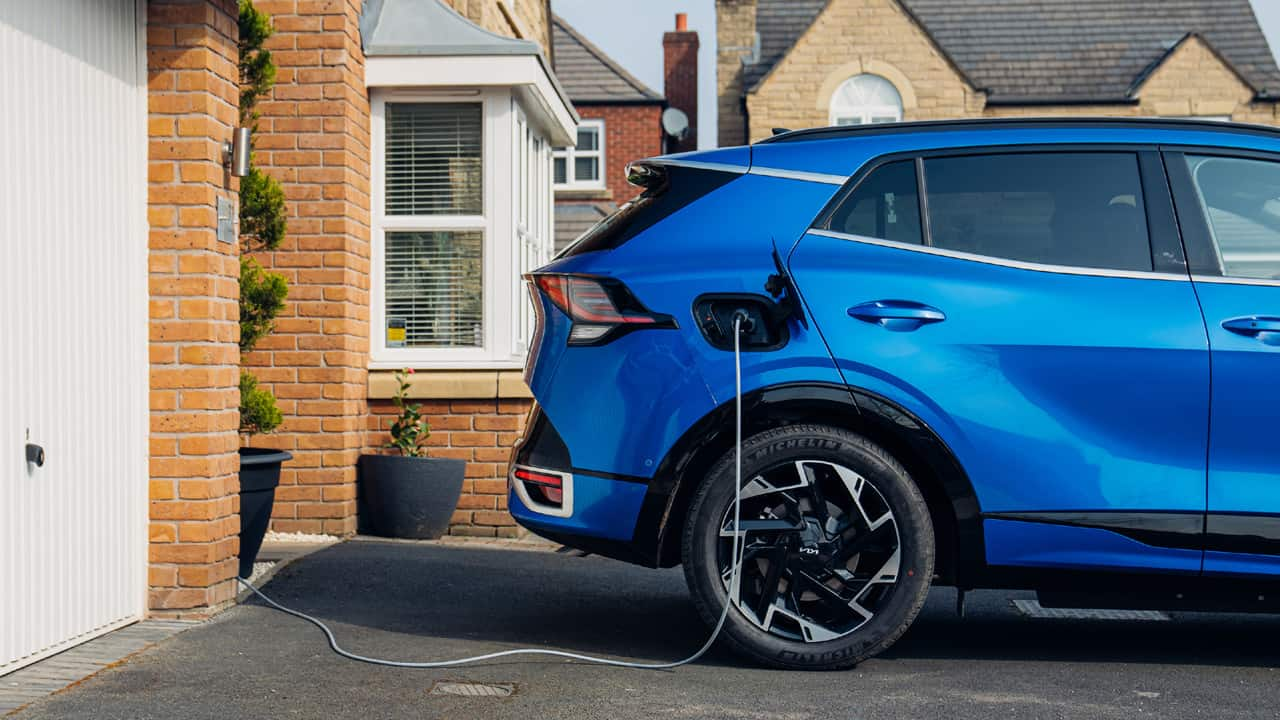 Blue Kia Sportage Charging