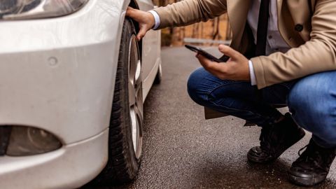 Man checking car wheel