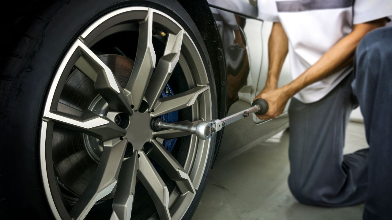 Man removing car wheel