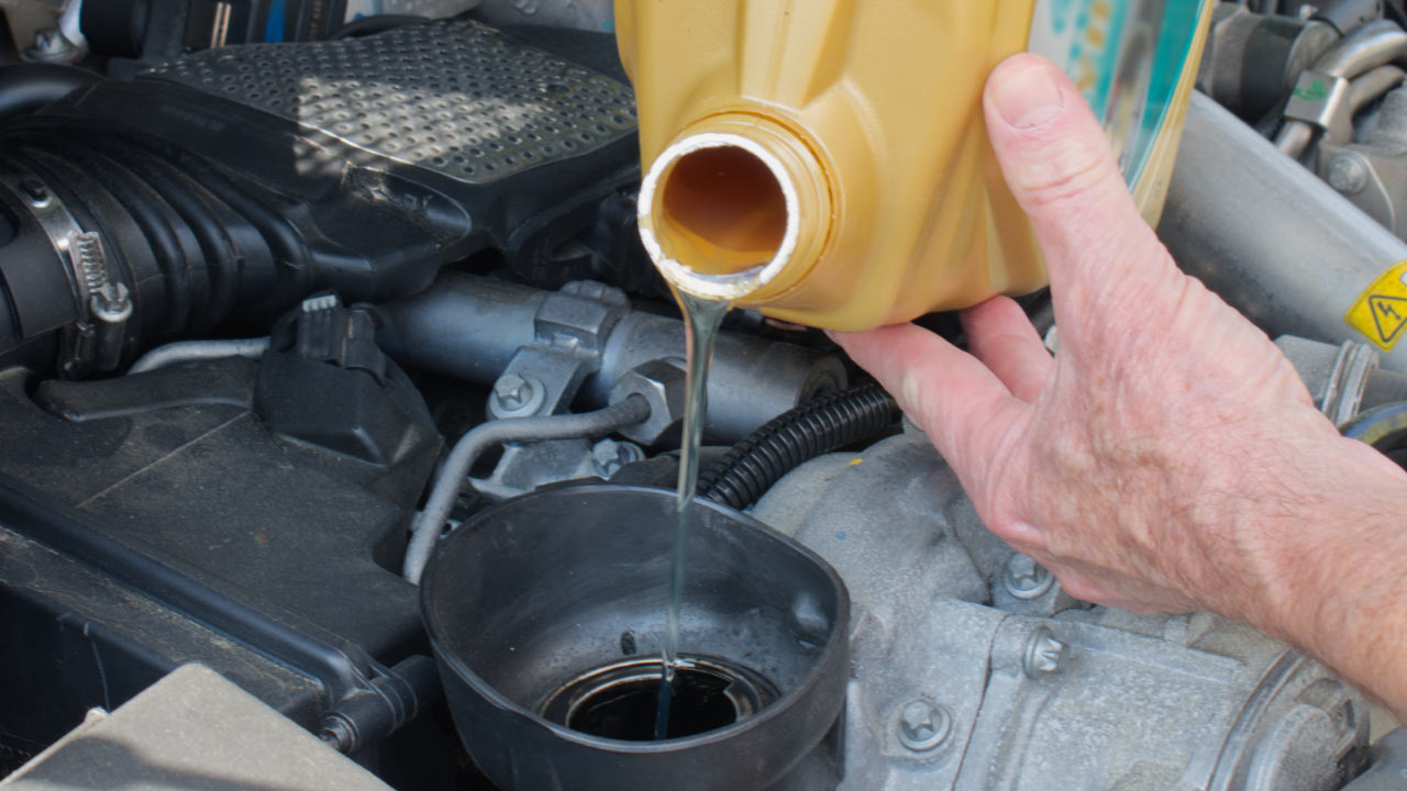 Man topping up brake fluid