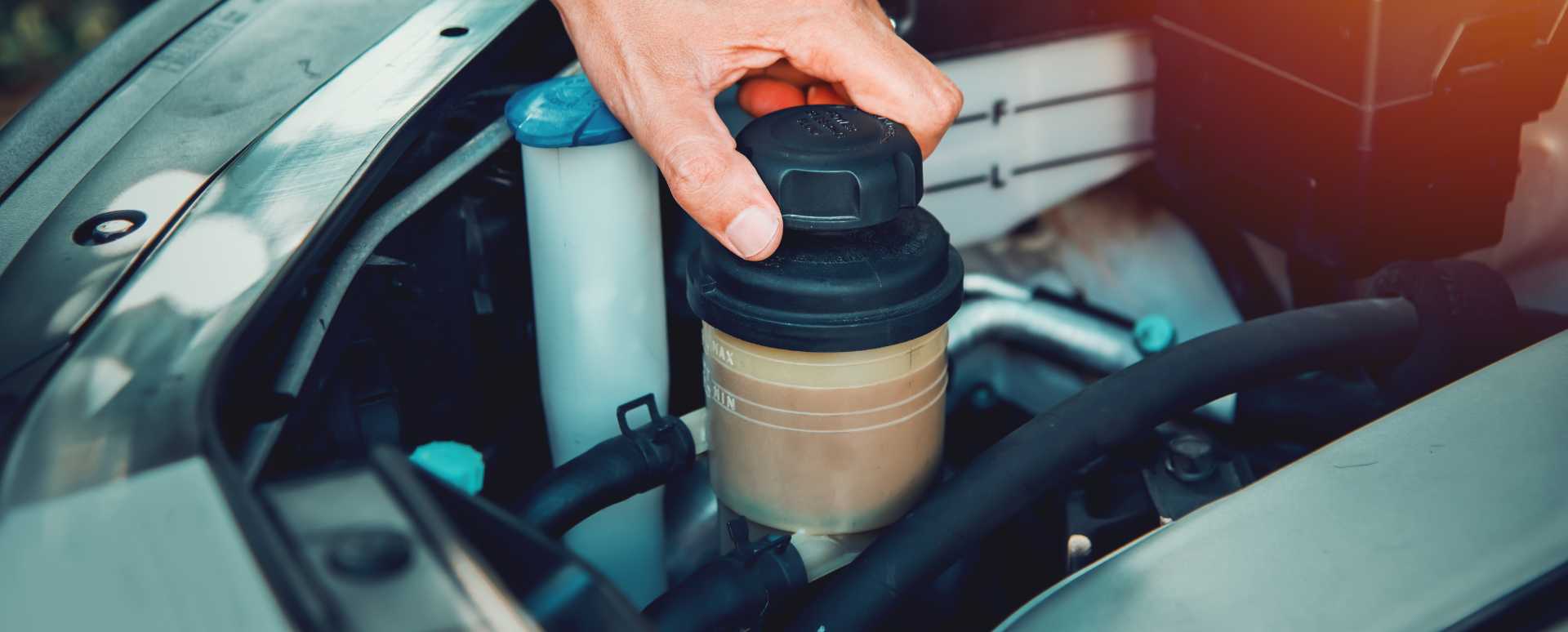 Man Opening the Power Steering Fluid Reservoir