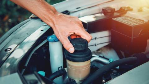 Man Opening the Power Steering Fluid Reservoir